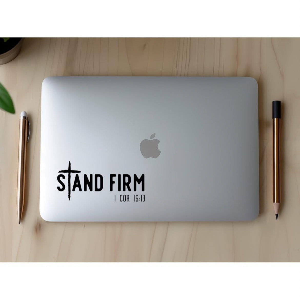 Laptop sticker decal  that says, “Stand firm” in large letters. The “T” in “stand” is a cross. Underneath in smaller letters it says, “1 Corinthians 16 13.”