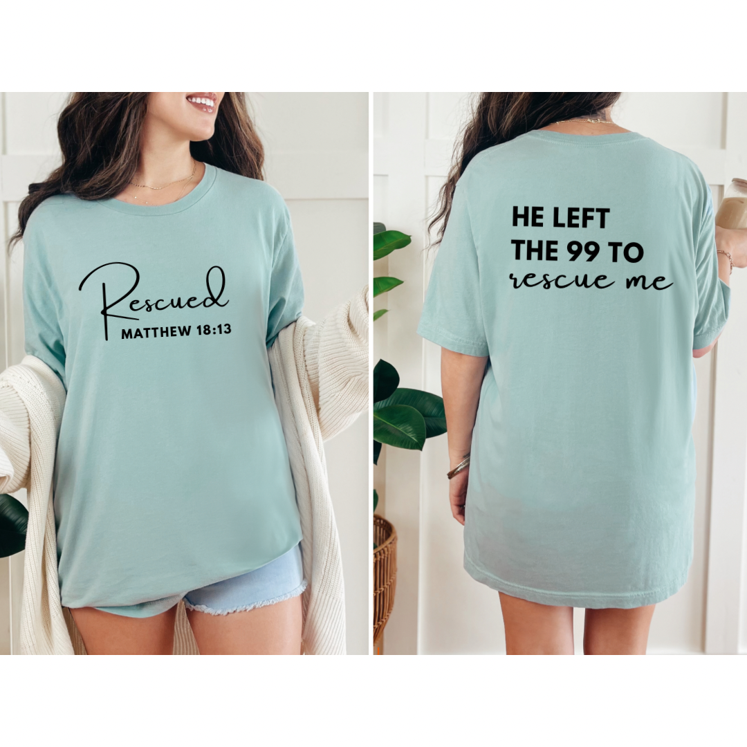 crewneck T-Shirt that says, "He left the 99 to rescue me". On the front it says, "Matthew 18:13 rescued" with a tan sheep.