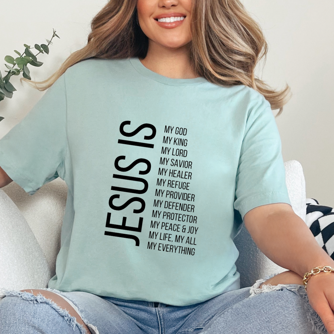 Dusty green crewneck t-shirt that says, “Jesus Is my, God, king, Lord, savior, healer, refuge, provider, defender, protection, peace. joy, life, all, everything.”