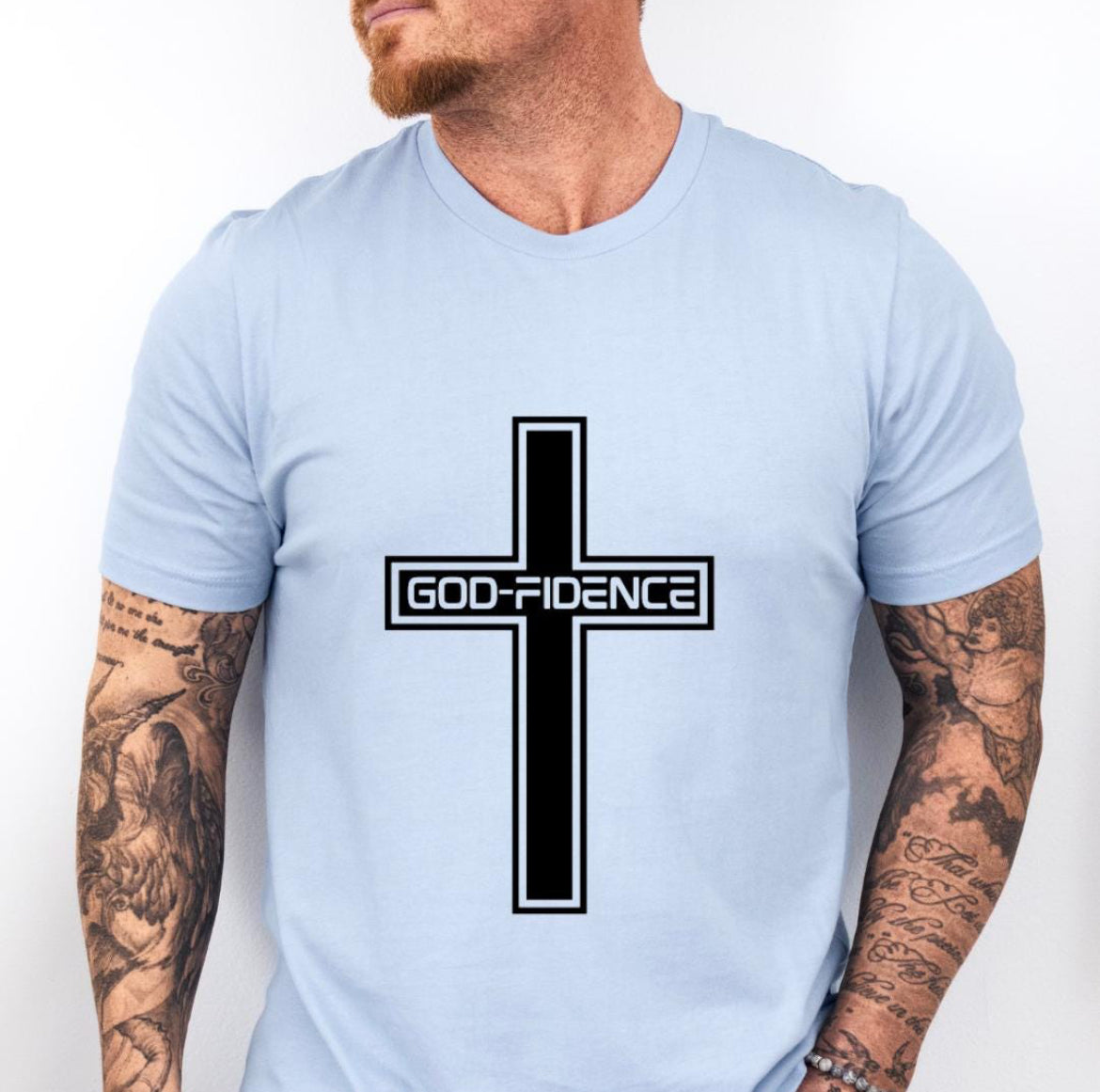 Baby blue crewneck t-shirt that says, “Godfidence” inside of a cross. 