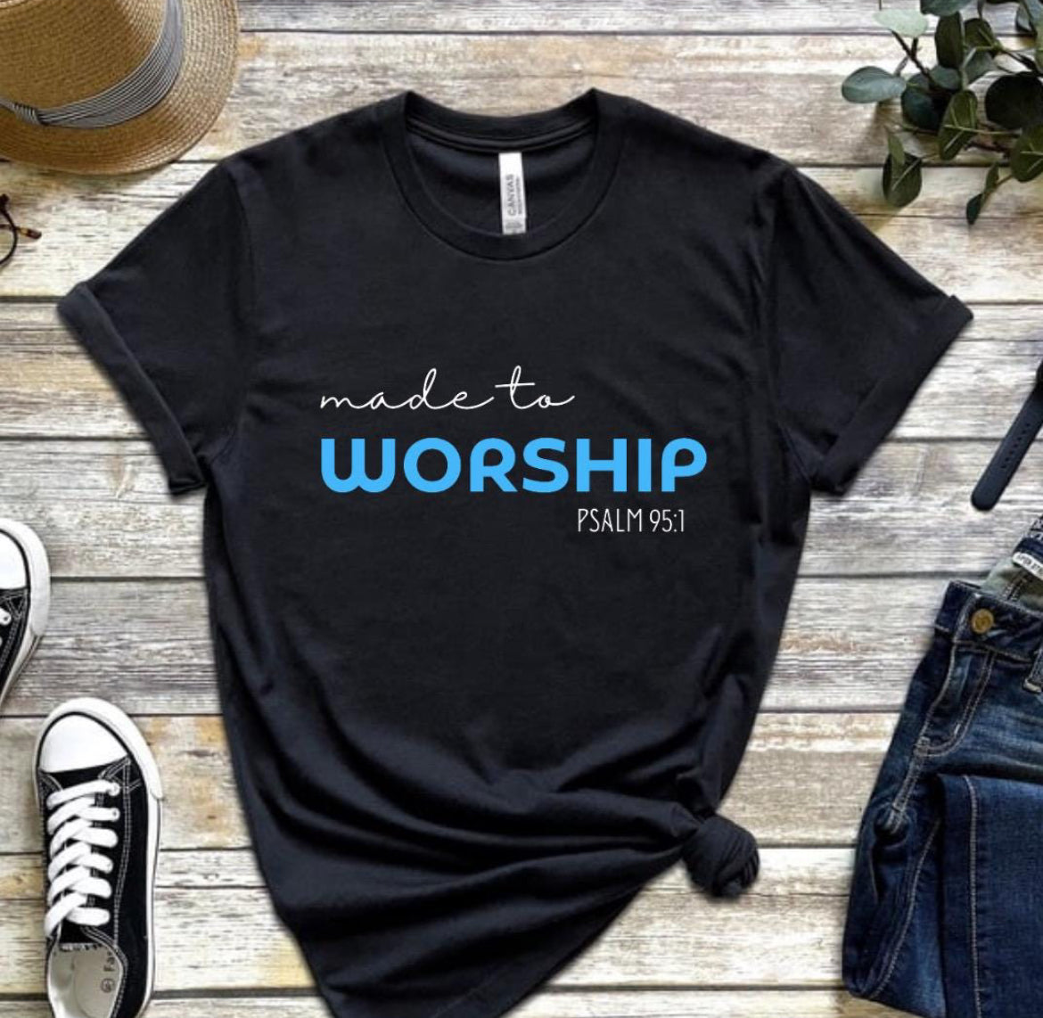 Black crewneck t-shirt that says, “made to worship” where the word “worship” is bold and blue. Underneath in smaller letters it says, “psalm 95 1.”