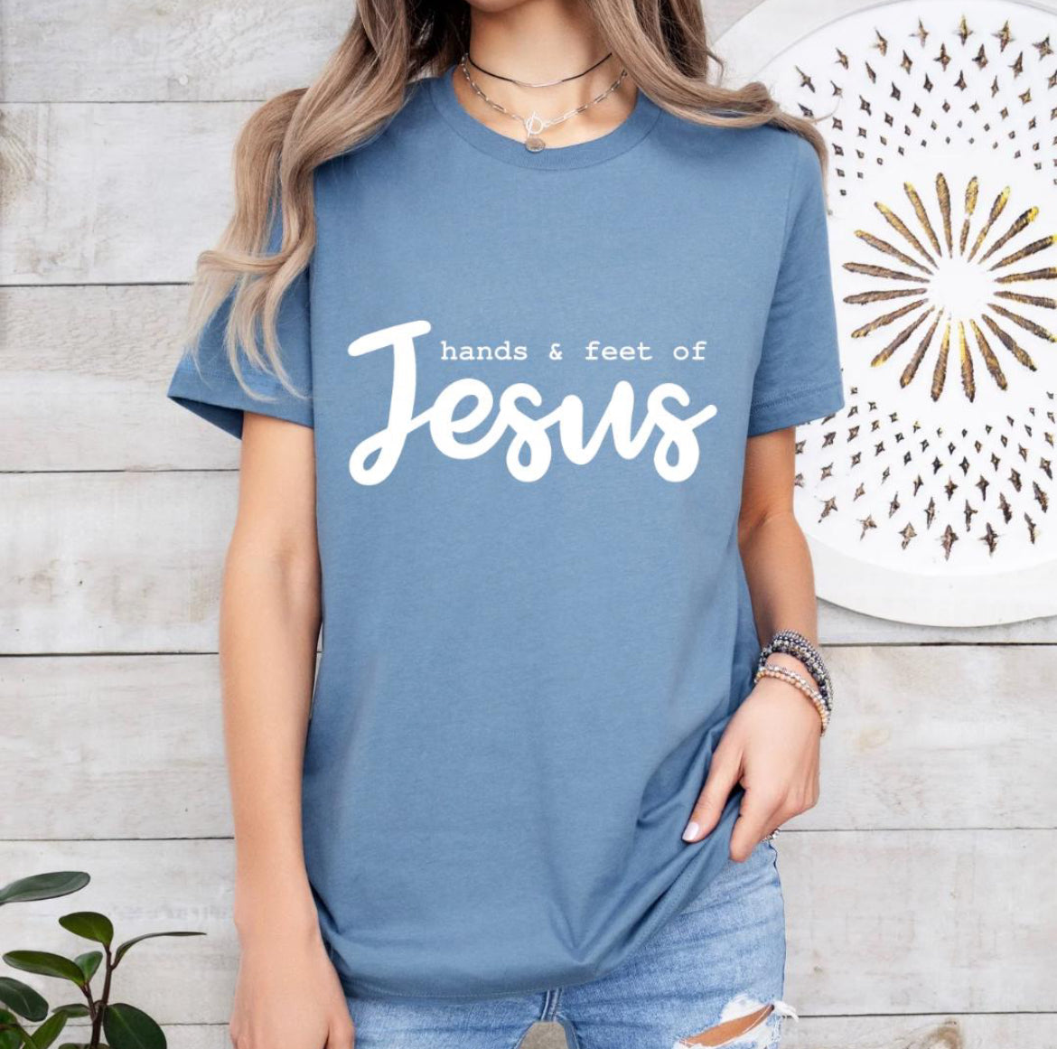 Steel blue crewneck t-shirt that says, “hands and feet of Jesus.”