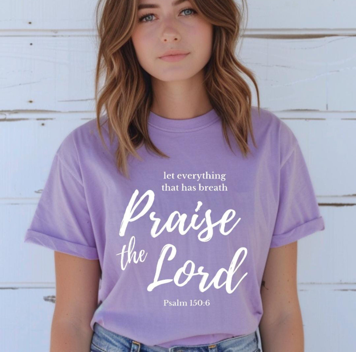 Lavender crewneck t-shirt that says, “let everything that has breath praise the Lord” underneath in small letters it says, “Psalm 150 6.”