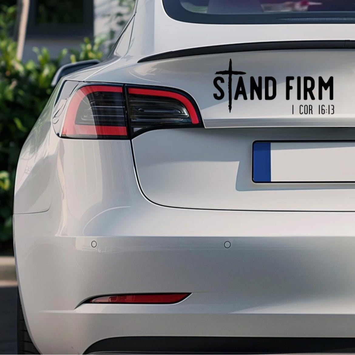 Bumper sticker decal  that says, “Stand firm” in large letters. The “T” in “stand” is a cross. Underneath in smaller letters it says, “1 Corinthians 16 13.”