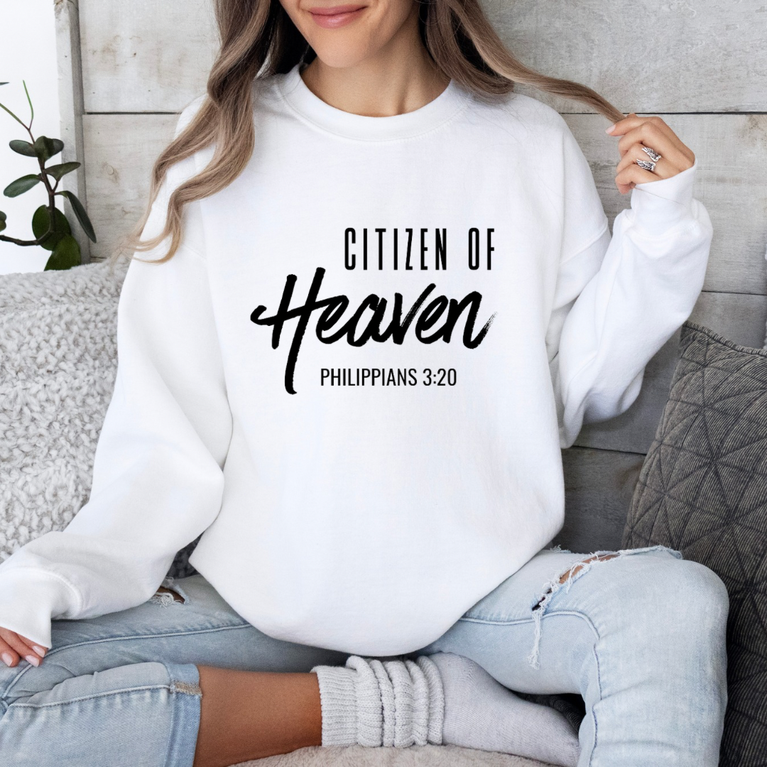 White crewneck sweatshirt that says, "Citizen of Heaven". Underneath in smaller writing it says, "Philippians 3 20."