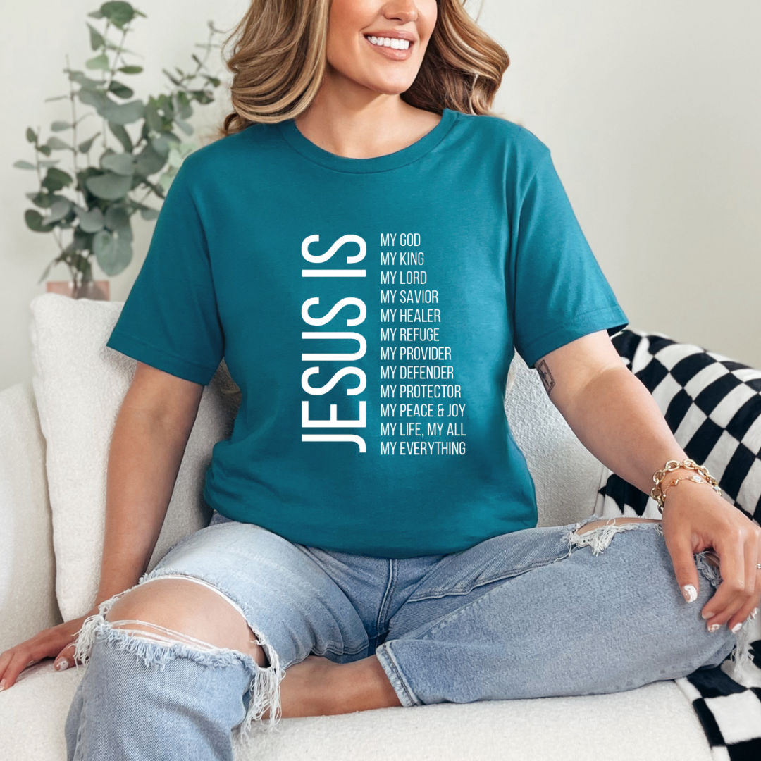 Deep teal crewneck t-shirt that says, “Jesus Is my, God, king, Lord, savior, healer, refuge, provider, defender, protection, peace. joy, life, all, everything.”