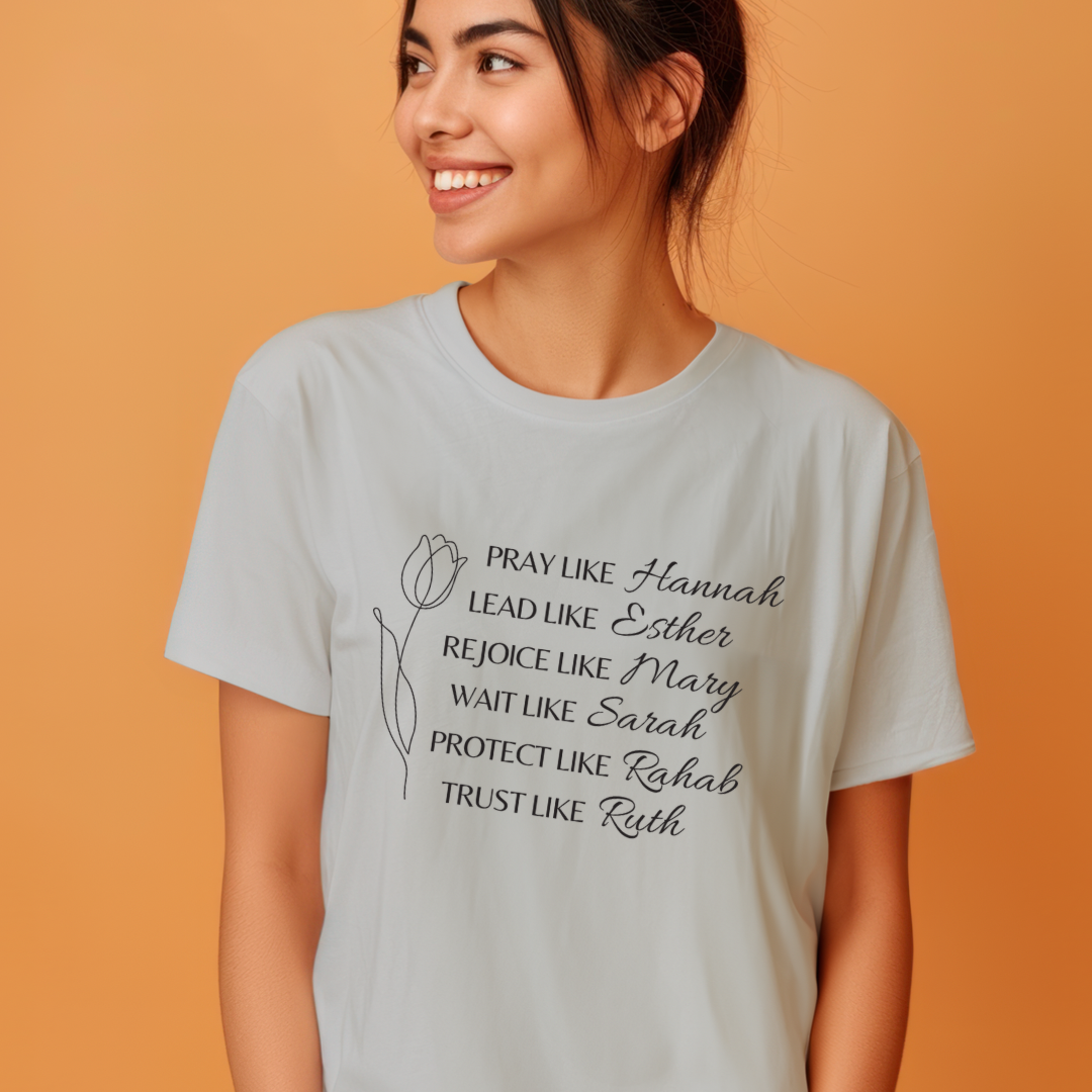 Grey crewneck t-shirt that says, "Pray like Hannah, lead like Esther, rejoice like Mary, wait like Sarah, protect like Rahab, trust like Ruth."