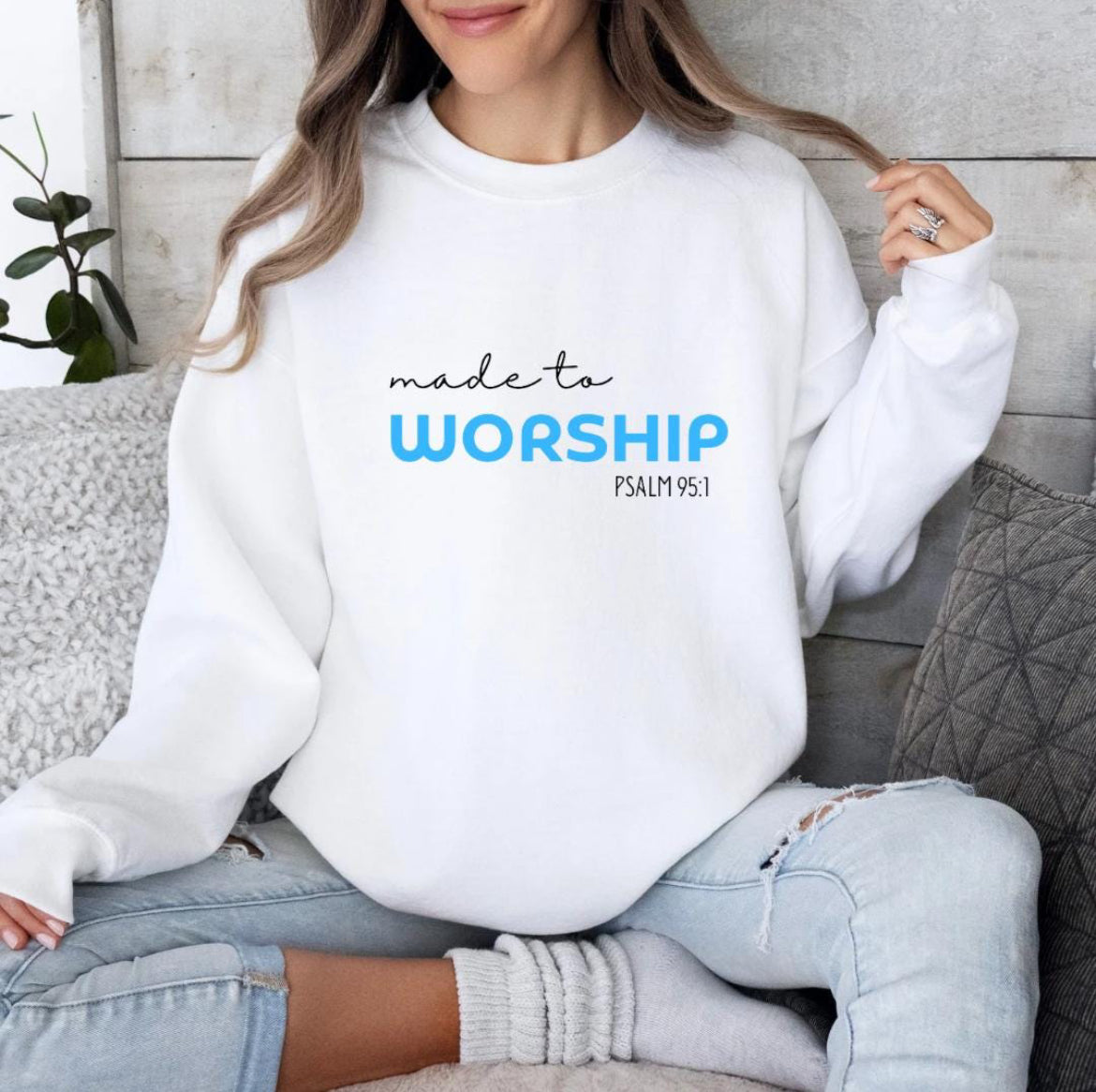 White crewneck sweatshirt that says, "Made to worship" where the word "worship" Is a bright blue. Underneath in smaller letters it says, "Psalm 95 1."