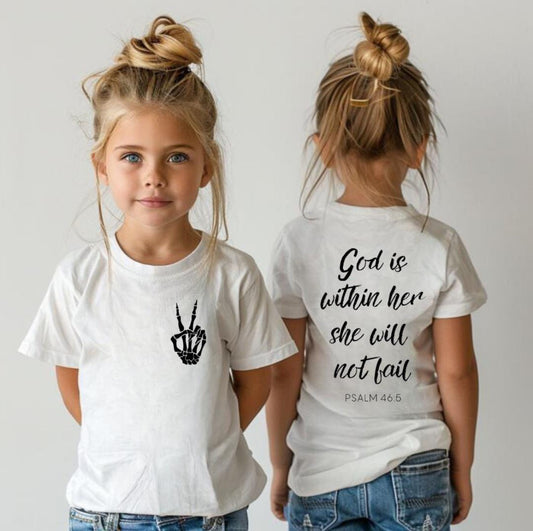 White Crewneck t-shirt that has a peace sign hand symbol made of bones in the upper left hand corner. On the back it says, “God is within her she will not fail.” Underneath in smaller letters it says, “Psalm 46 5.”