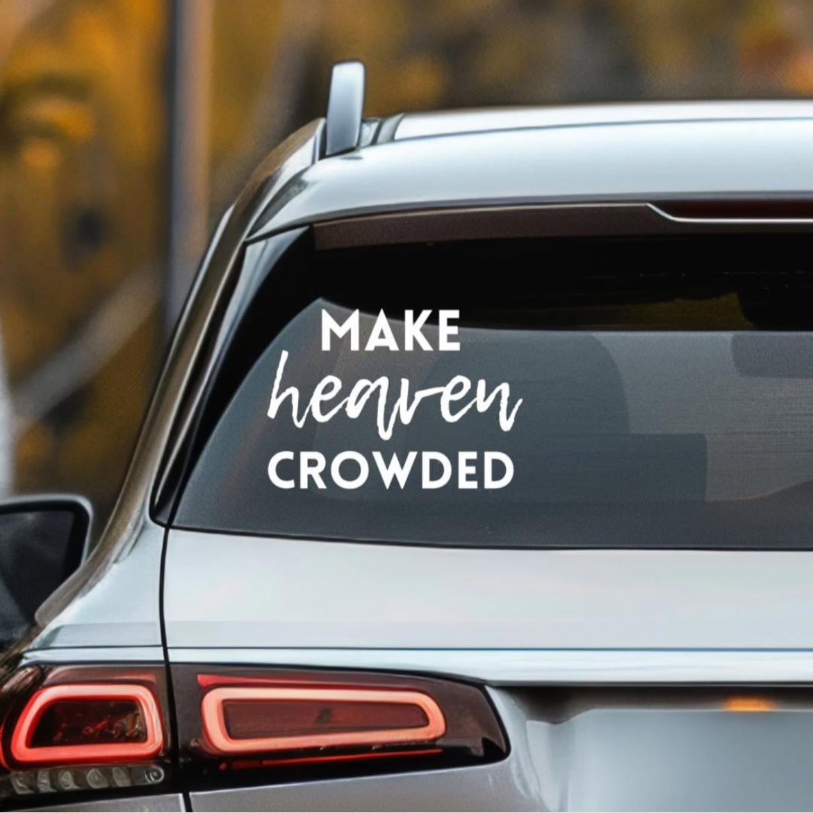 Car decal that says, “make heaven crowded.” The word “heaven” is in cursive. 