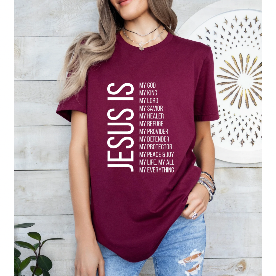 Maroon crewneck t-shirt that says, “Jesus Is my, God, king, Lord, savior, healer, refuge, provider, defender, protection, peace. joy, life, all, everything.”