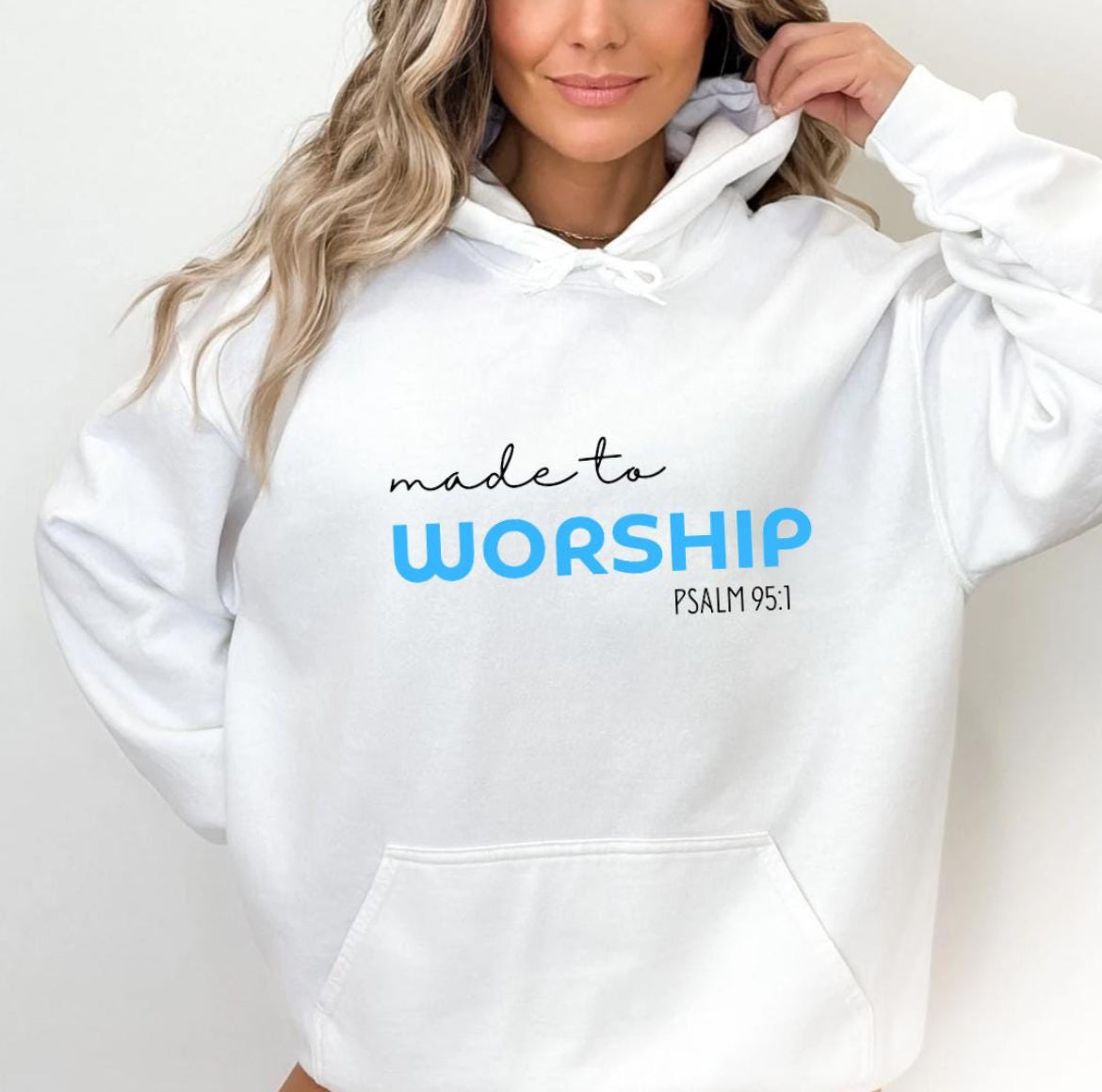 Whtie hoodie that says, "Made to worship" where the word "worship" Is a bright blue. Underneath in smaller letters it says, "Psalm 95 1."