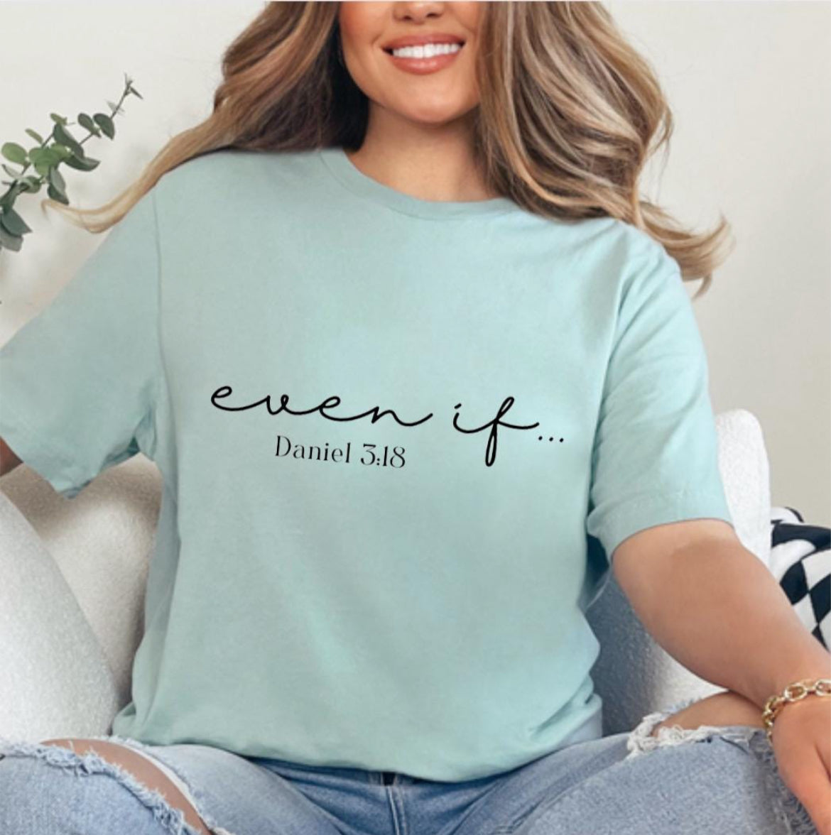 Dusty green crewneck t-shirt that says, “even if…” in cursive letters. Underneath in smaller letters it says, “Daniel 3 18.”