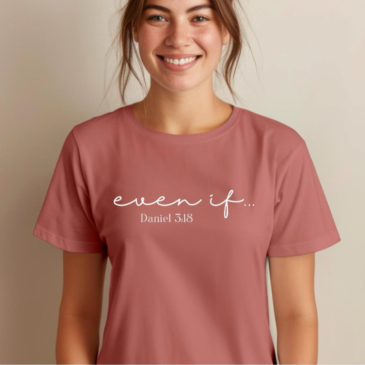 Mauve crewneck t-shirt that says, “even if…” in cursive letters. Underneath in smaller letters it says, “Daniel 3 18.”