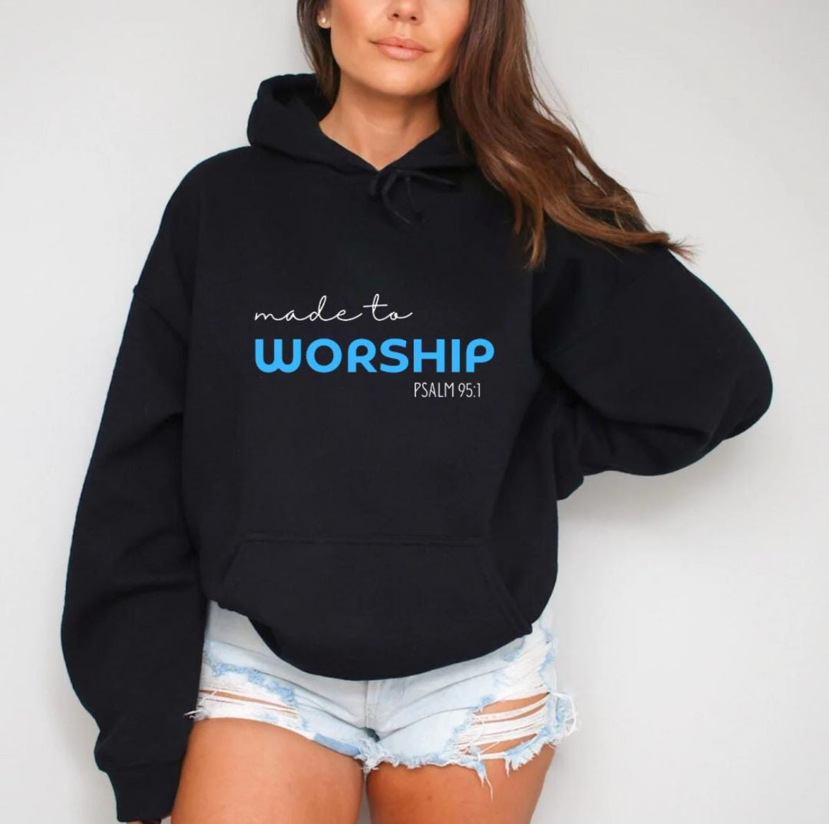 Black hoodie that says, "Made to worship" where the word "worship" Is a bright blue. Underneath in smaller letters it says, "Psalm 95 1."