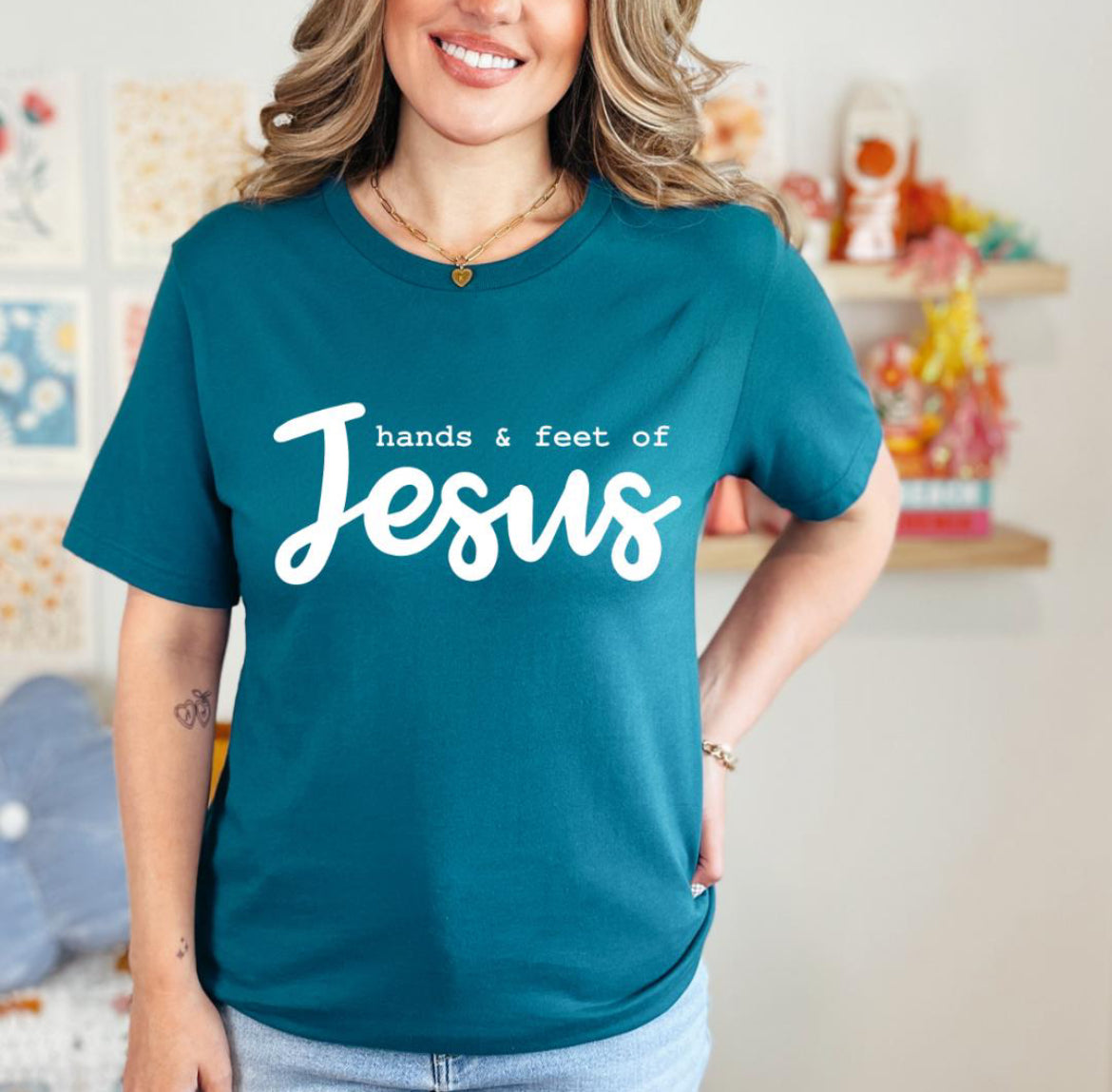 Deep teal crewneck t-shirt that says, “hands and feet of Jesus.”