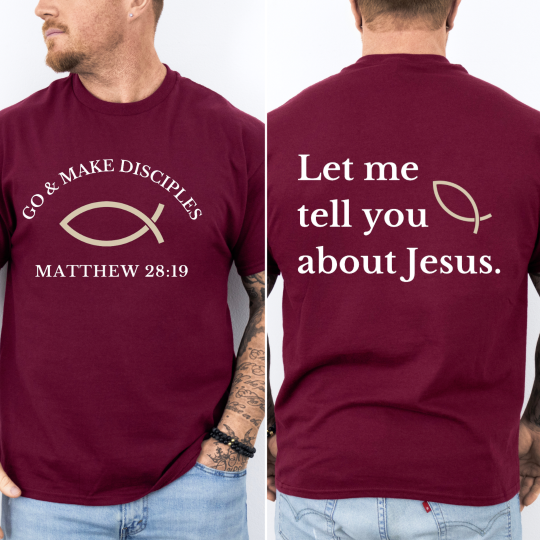 Maroon crewneck t shirt that says, "Go and make disciples, Matthew 28 19 on the front." On the back it says, "Let me tell you about Jesus." There is an ichthus Jesus fish symbol on the front and back. 