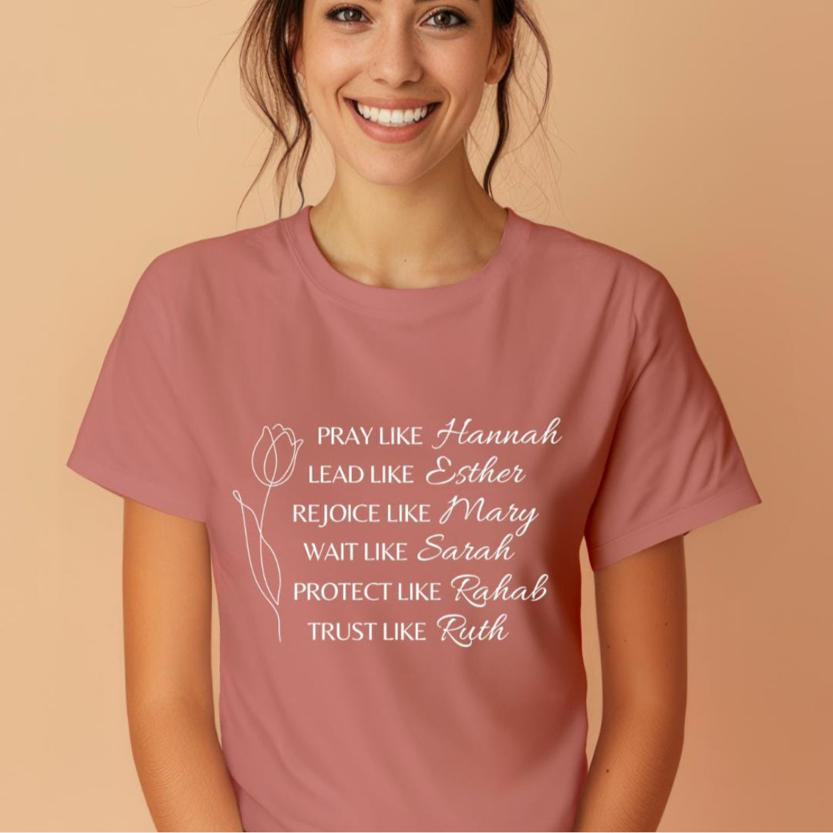 Mauve crewneck t-shirt that says, “Pray like Hannah, lead like Esther, rejoice like Mary, wait like Sarah, protect like Rahab, trust like Ruth.”