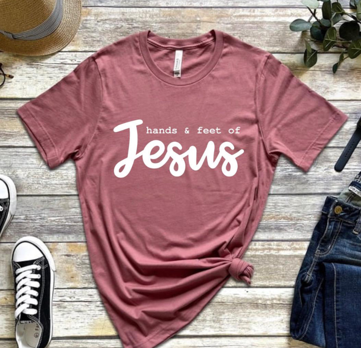 Mauve crewneck t-shirt that says, “hands and feet of Jesus.”