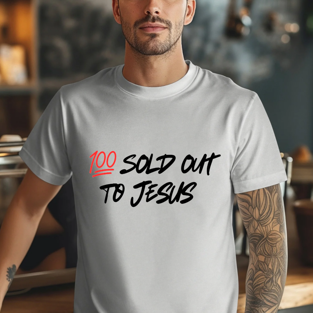 Grey crewneck t-shirt that says, “sold out to Jesus” with a “100 emoji”.