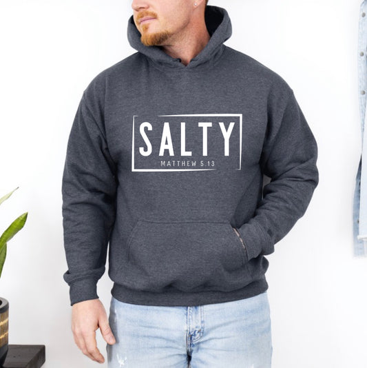 Dark grey heather hoodie sweatshirt that says, “SALTY” in large capital letters. Underneath in smaller letters it says, “Matthew 5:13.”