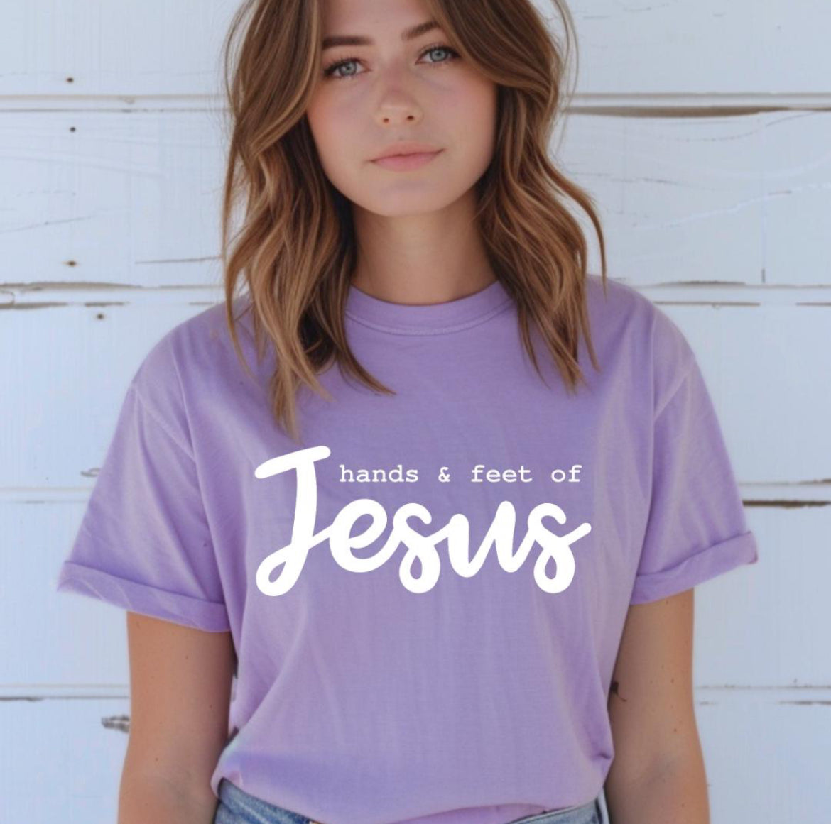 Lavender crewneck t-shirt that says, “hands and feet of Jesus.”