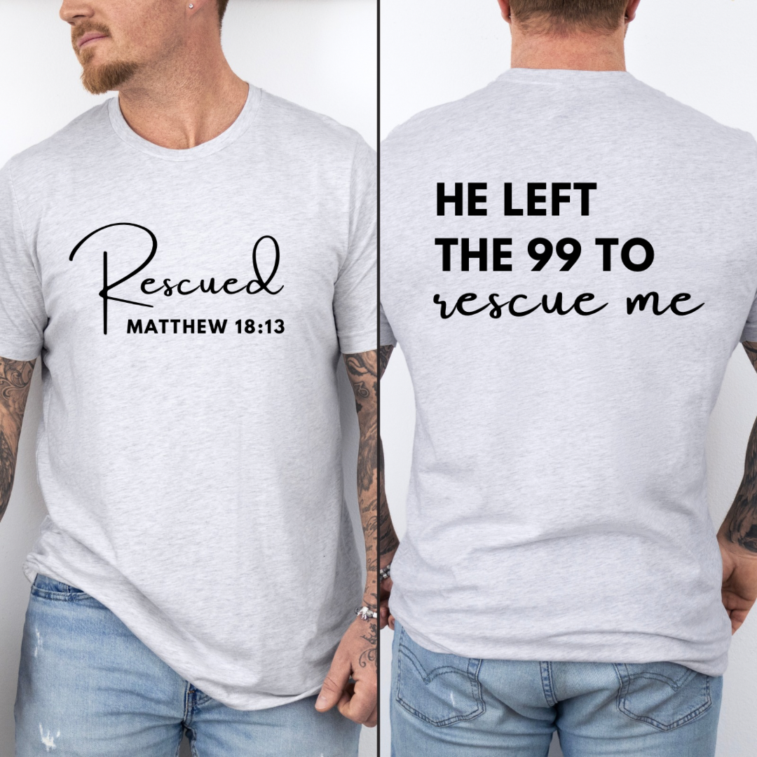 crewneck T-Shirt that says, "He left the 99 to rescue me". On the front it says, "Matthew 18:13 rescued" with a tan sheep.