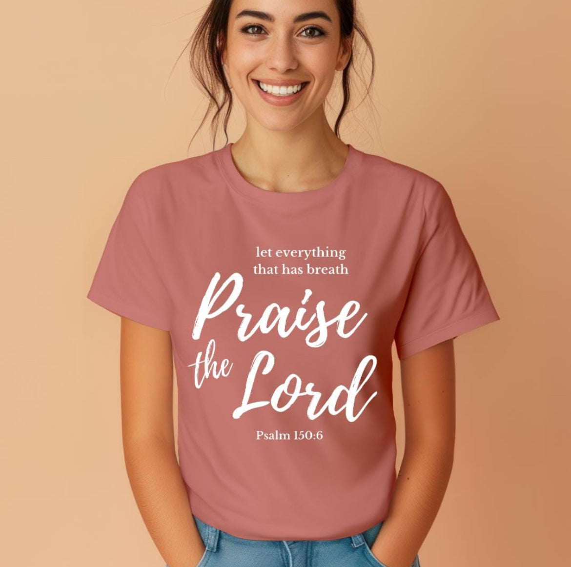 Mauve crewneck t-shirt that says, “let everything that has breath praise the Lord” underneath in small letters it says, “Psalm 150 6.”