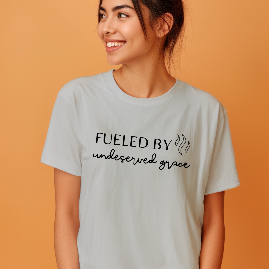 Grey crewneck t-shirt that says, “Fueled by undeserved Grace”.