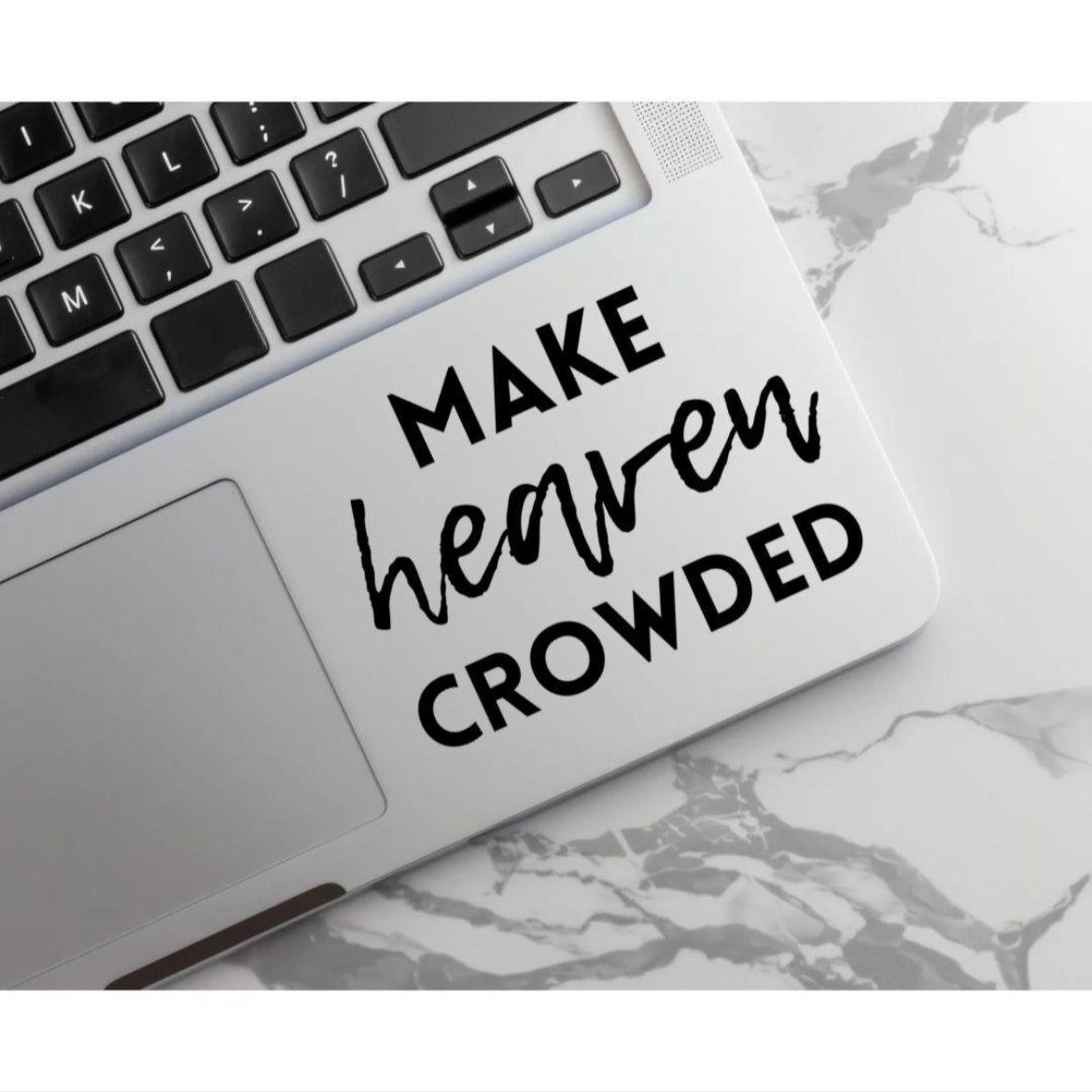 Laptop keyboard sticker decal that says, “make heaven crowded.” The word “heaven” is in cursive. 