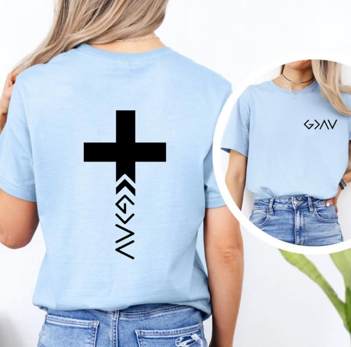 Baby blue crewneck t-shirt with a cross on the back that has the symbol “God is greater than the highs and lows” as the bottom part of the cross.  The front has the same symbol in the upper left-hand corner.