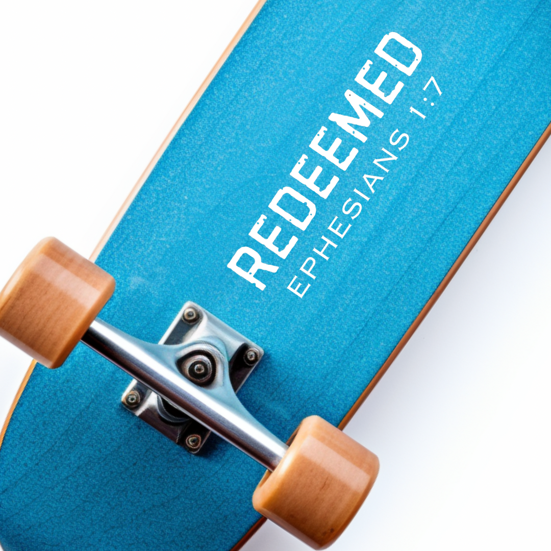 Skateboard sticker decal that says, “Redeemed” in large bold distressed letters. Underneath in smaller capital letters it says, “Ephesians 1 7.”