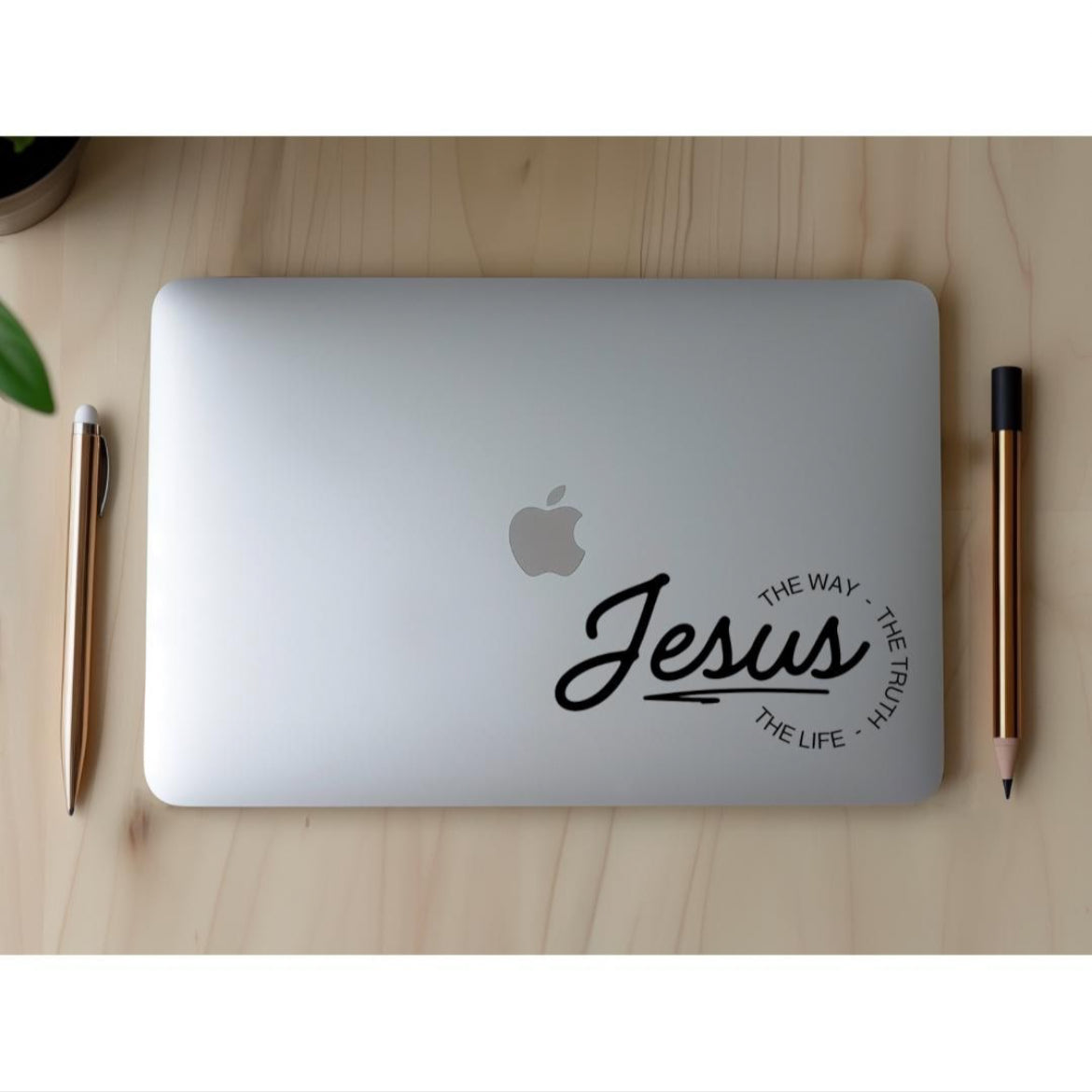 Laptop sticker decal that says, “Jesus - the way, the truth, the life.” The word “Jesus” is in large cursive letters. The other words are in print and round the ending of “Jesus”.