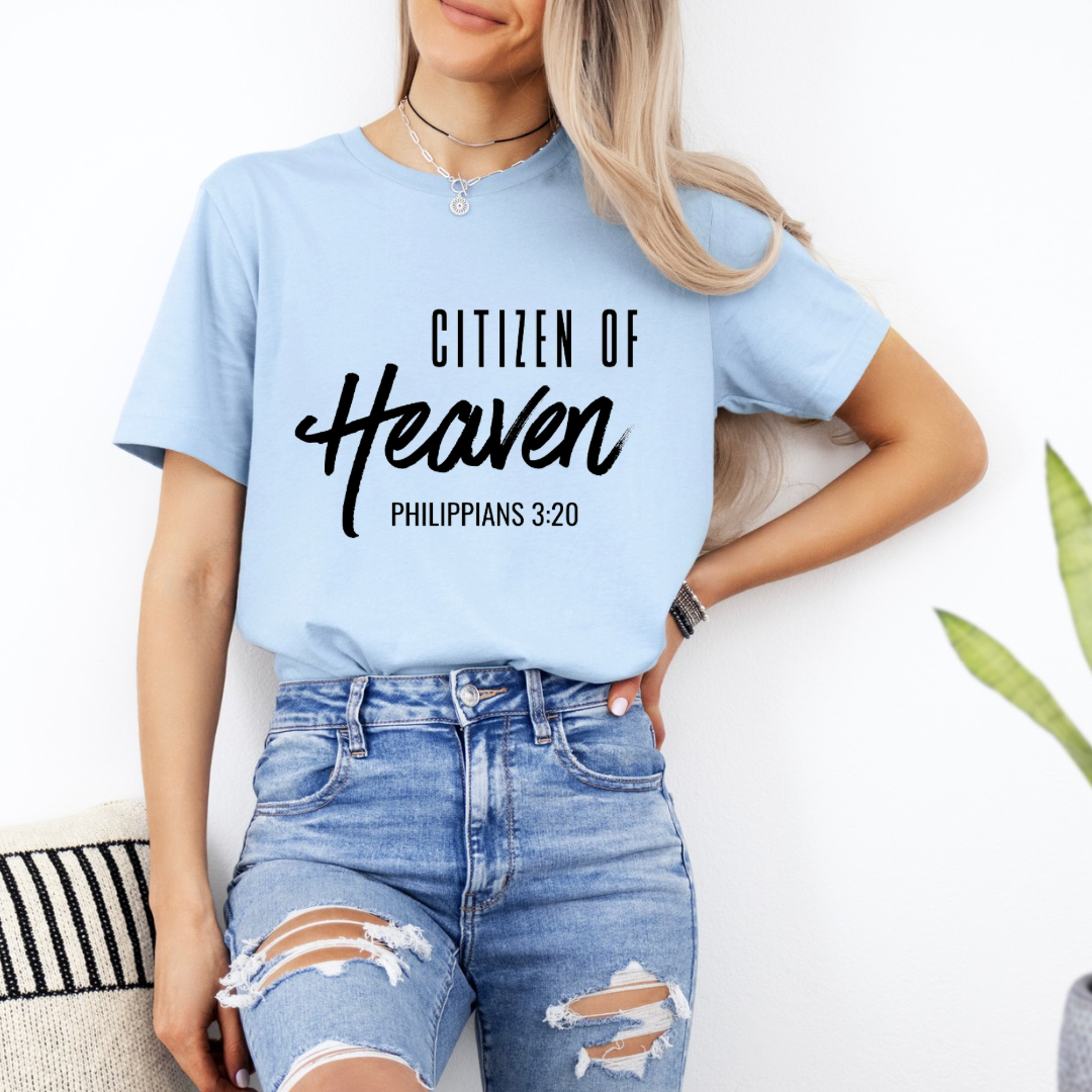 Baby blue crewneck t-shirt that says, "Citizen of Heaven". Underneath in smaller writing it says, "Philippians 3 20."