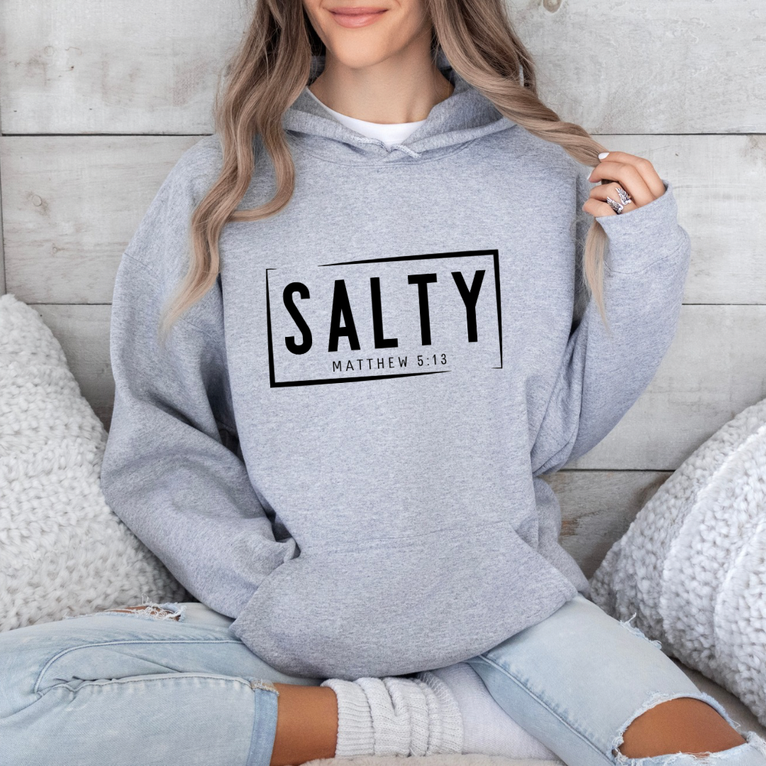 Grey hoodie sweatshirt that says, “SALTY” in large capital letters. Underneath in smaller letters it says, “Matthew 5:13.”