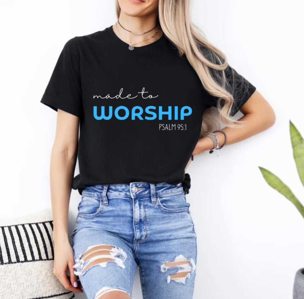 Black crewneck t-shirt that says, “made to worship” where the word “worship” is bold and blue. Underneath in smaller letters it says, “psalm 95 1.”