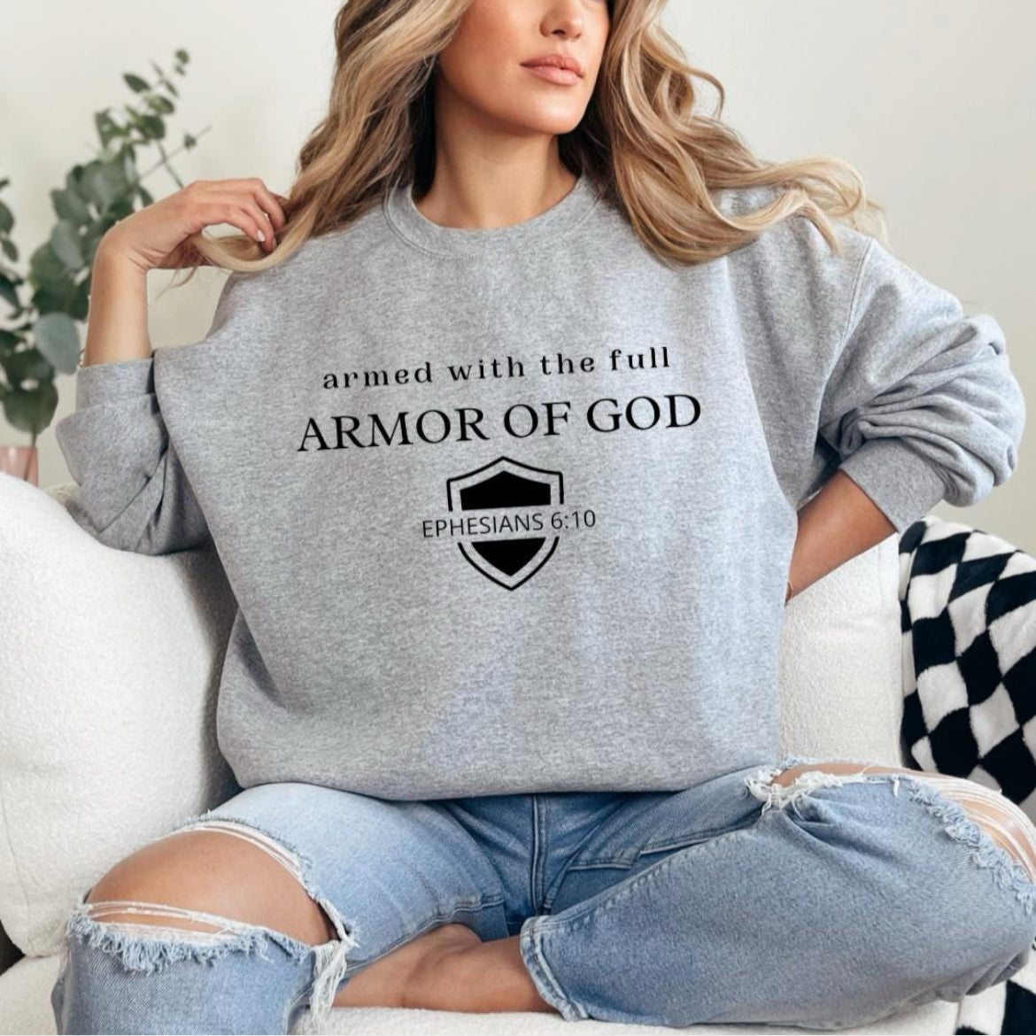 Light gray crewneck that says, "armed with the full armor of God." Underneath is a shield and in the middle of the shield it says, "Ephesians 6 10."