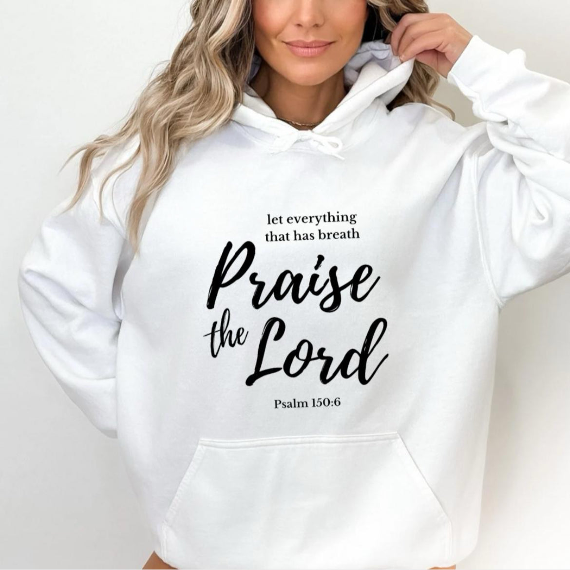 White hoodie that says, "Let everything that has breath Praise the Lord." Underneath it says, "Psalm 150 verse 6."