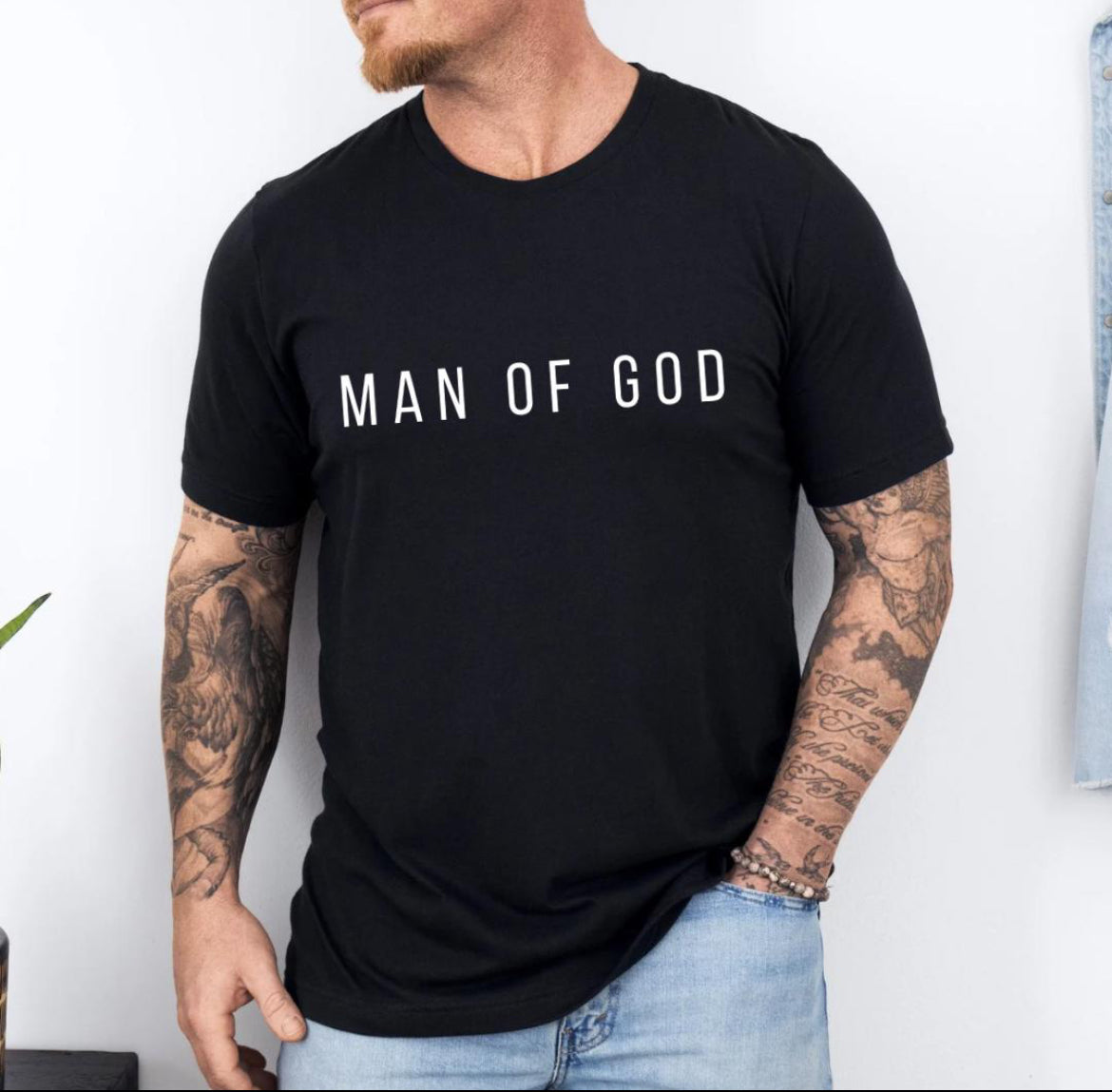 Black crewneck t-shirt that says, “man of God” in large bold letters.