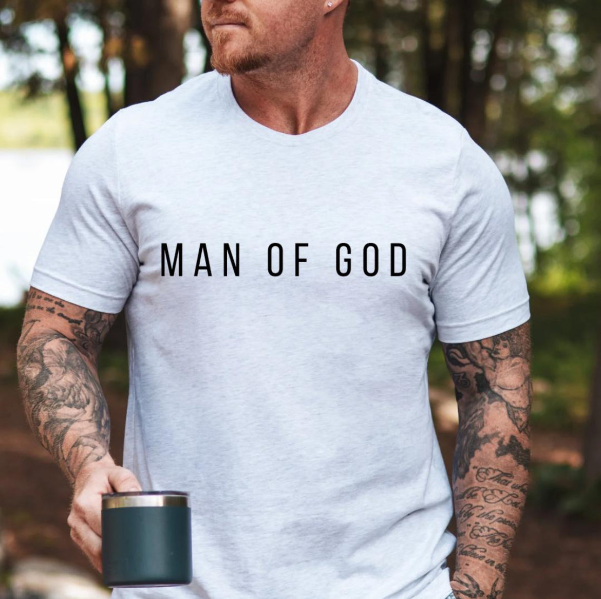 Ash white crewneck t-shirt that says, “man of God” in large bold letters.