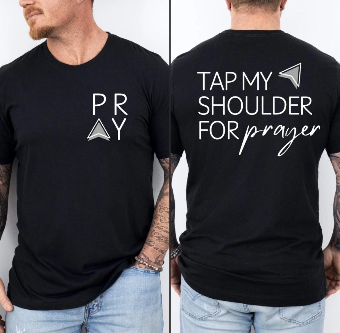 Black Crewneck t-shirt that says, “tap my shoulder for prayer” with an aesthetic arrow pointing to the shoulder. On the front of the shirt it says, “PRAY” up in the left-hand corner of the shirt. 