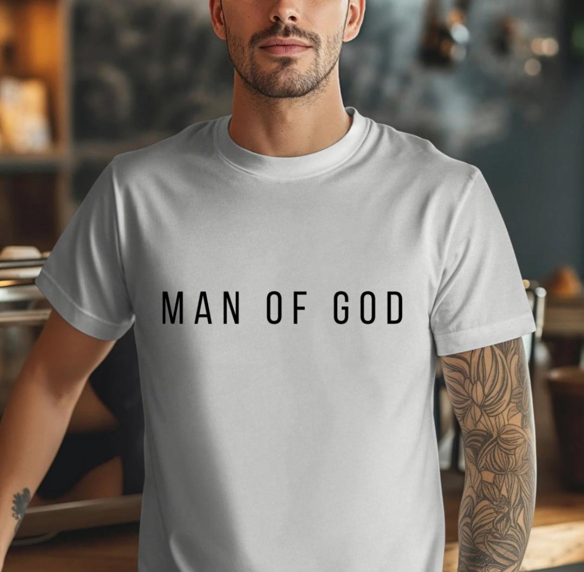 Grey crewneck t-shirt that says, “man of God” in large bold letters.