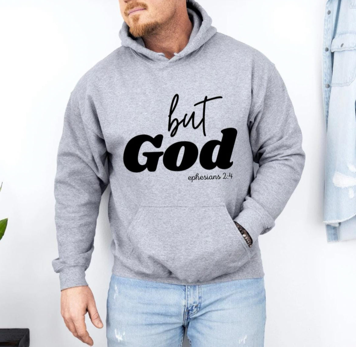 Sporty gray hooded sweatshirt that says, "But God" in large letters. Underneath it says, "Ephesians 2 verse 4" in smaller letters. 