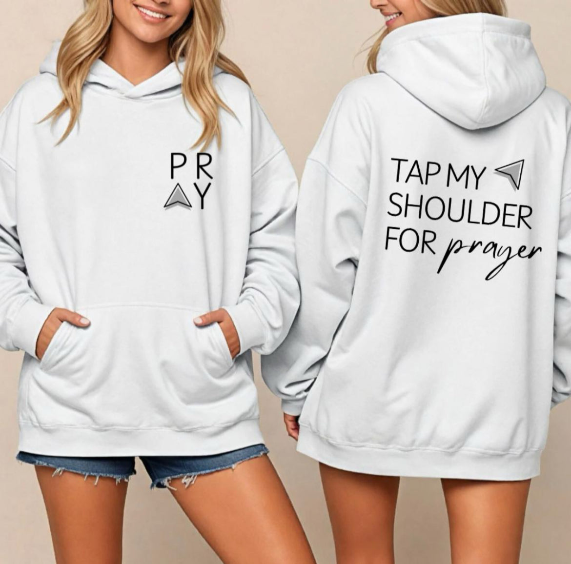 White hoodie that says, "PRAY" where the A is an arrow in the front left-hand corner of the hoodie. Back has an aesthetic arrow pointing towards the shoulder that says, "Tap my shoulder for prayer."