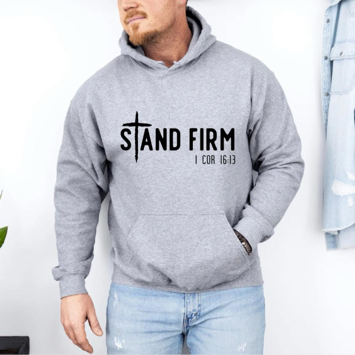 Light gray hoodie that says, "Stand firm" where the "t" is a cross.  Underneath in smaller letters it says, "1 Corinthians 16 verse 13."