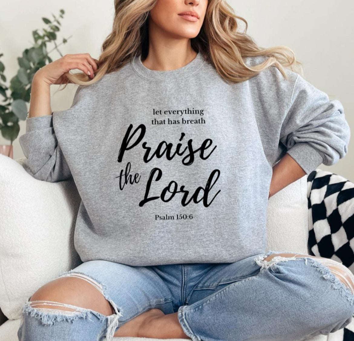 Light grey crewneck sweatshirt that says, "Let everything that has breath Praise the Lord." Underneath it says, "Psalm 150 verse 6."