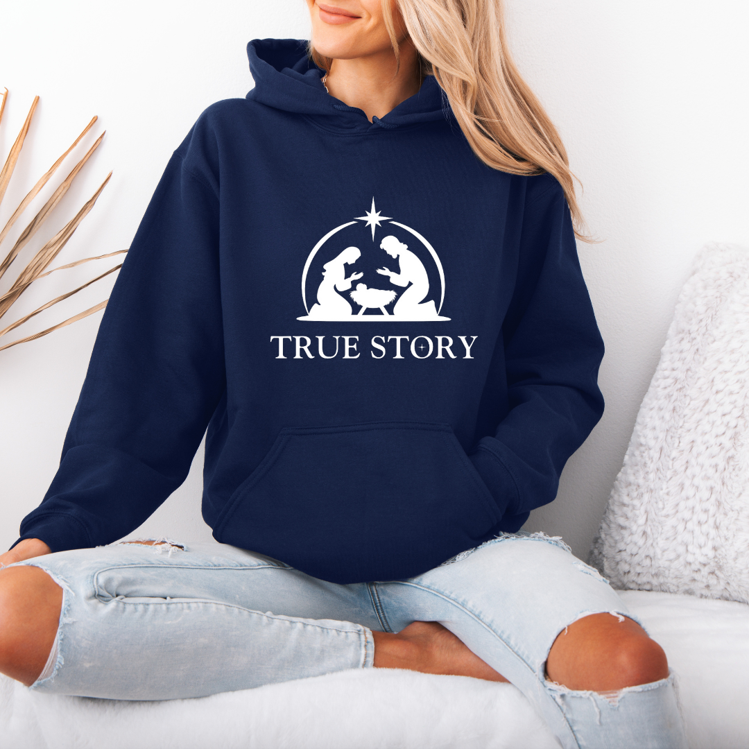 Navy hooded sweatshirt that says, "True story" with an image of Baby Jesus, Mary & Joseph in a manger.