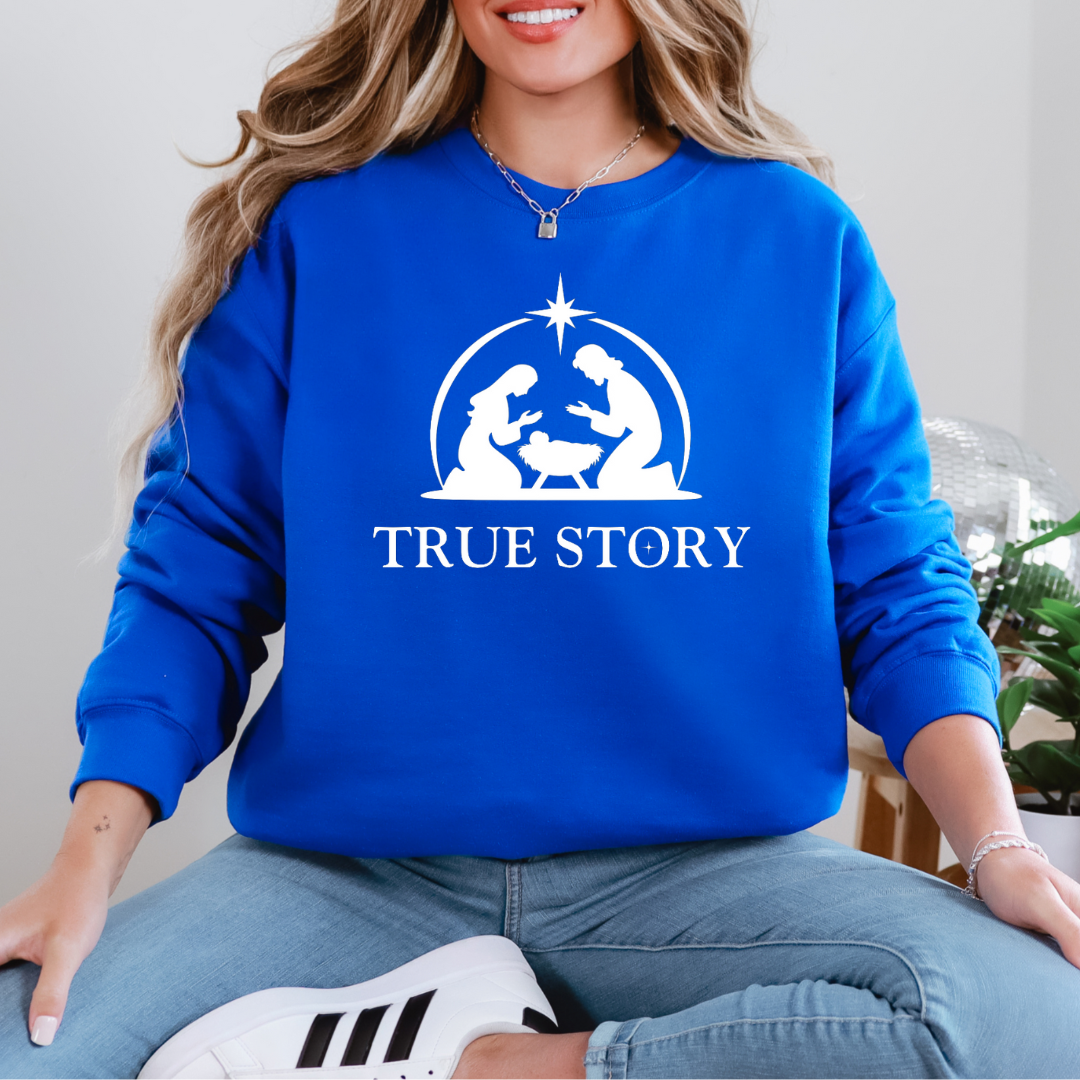 Royal Blue sweatshirt that says, "True story" with an image of Baby Jesus, Mary & Joseph in a manger.