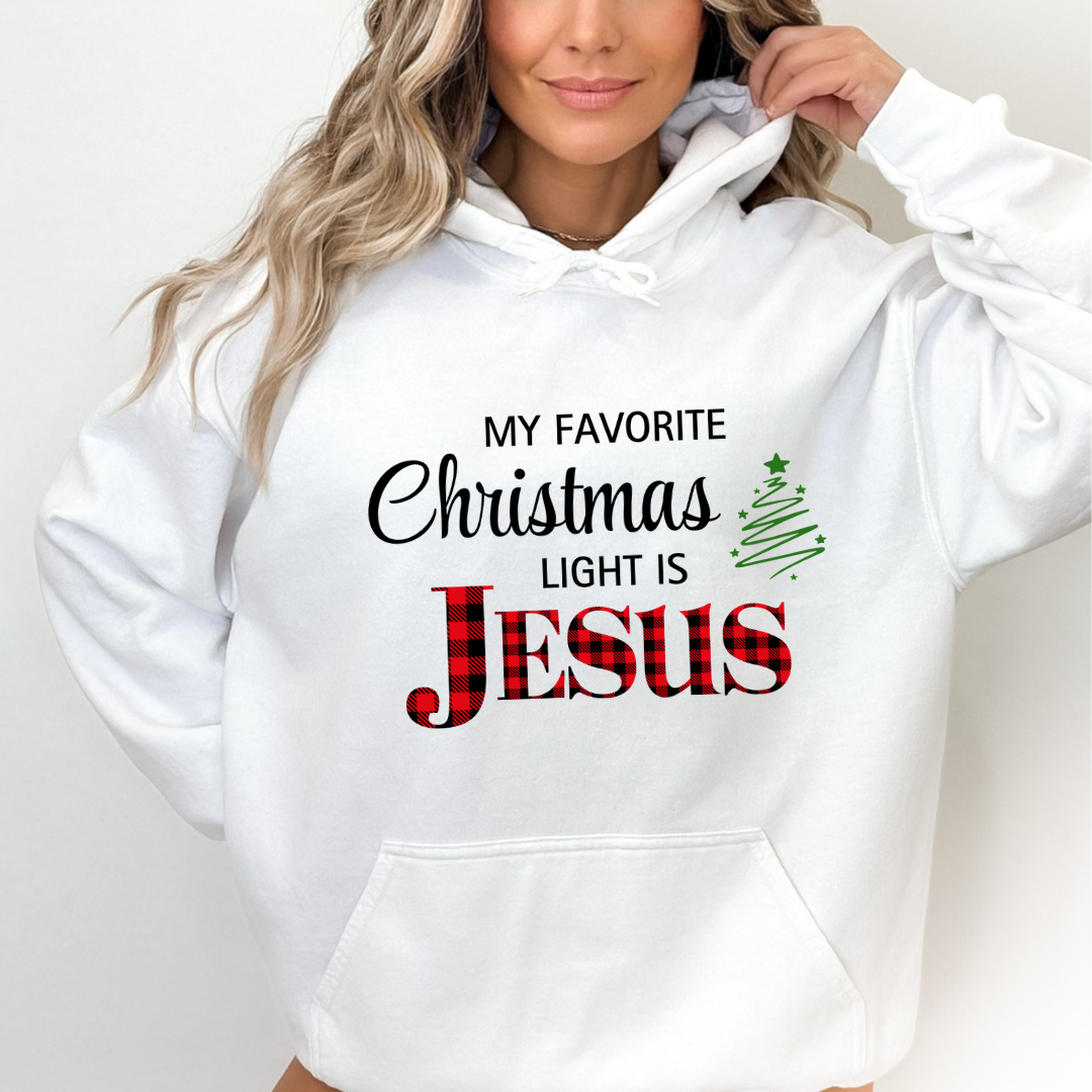 White hoodie sweatshirt that says, "My favorite Christmas light is Jesus." Jesus is in buffalo plaid red with a green Christmas tree graphic.