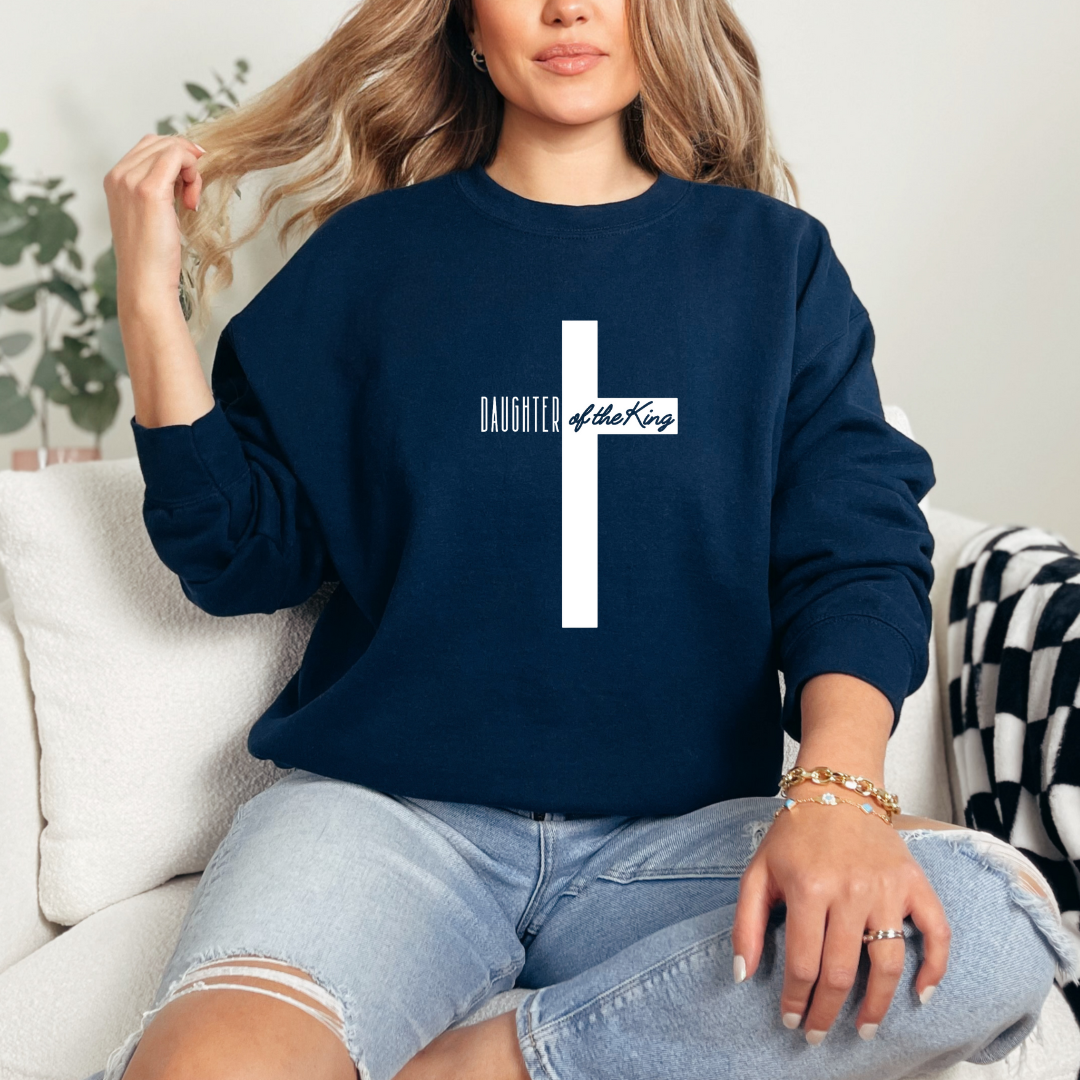 Navy sweatshirt that says, "daughter of the King" across the middle of a large cross. 